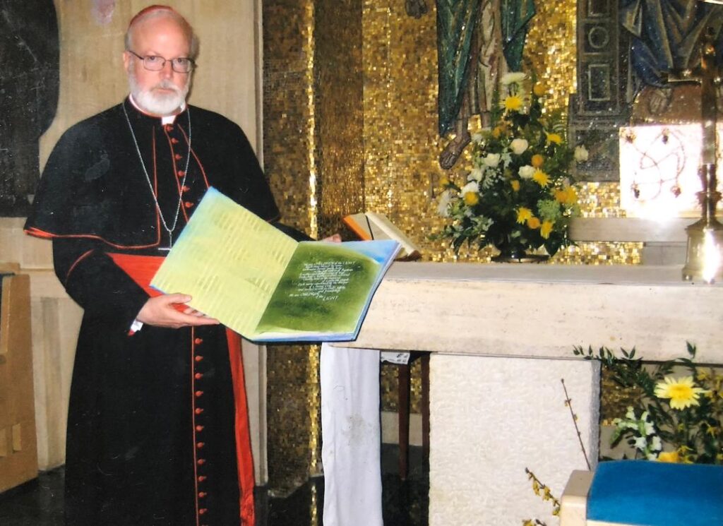 Cardinal Sean O'Malley holding the book of names